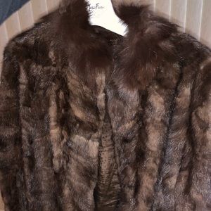 This is a brown mink jacket with Fox fur collar.